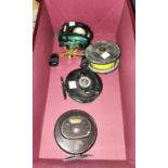 Three fly fishing reels and a spinning reel