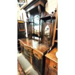 An edwardian carved walnut sideboard with raised mirror bac, 5 drawers and 2 cupboards