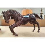 A leather model of a small horse with glass eyes