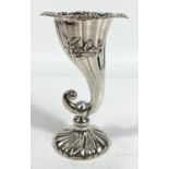 A silver vase in the form of a cornucopia with cast rim and tapering spiral fluted body
