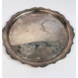 A hallmarked silver circular salver with wavy border, Sheffield 16oz, diameter 26cm