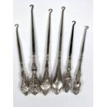 Six various hall marked silver handled button hooks with different designs, dates and assay offices