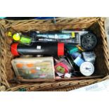A fishing basket with lures, spools and other equipment