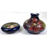 A Moorcroft pin dish with floral decoration, 11cm; a Moorcroft vase (large chip to rim)