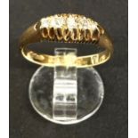 An Edwardian 18 carat hallmarked gold dress ring with 5 graduating diamonds in split shank