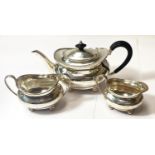 A hallmarked silver 3 piece tea service:  teapot with ebonised handle, milk jug and sugar bowl, on