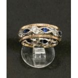 A two tone yellow and white metal dress ring set with blue and white sapphires, 3.6gms, size K