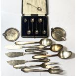 A cased set of six hall marked silver coffee bean spoons, Sheffield 1922, two white metal ashtrays