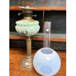 A Victorian opaque moulded green glass oil lamp on a gilt Corinthian column with a chimney and
