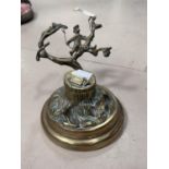 A Victorian brass desk ink well in the form of tree stump with boy swinging from the branches