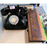 A vintage call exchange, black composition, rotary dial telephone and a poker work portable book