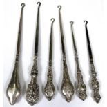 Six various hall marked silver handled button hooks with different designs, dates and assay offices