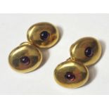 A pair of 18ct gold gents cufflinks set with red stone, 8.8gm