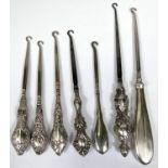 Seven various silver hall marked button hooks with different designs, assay offices etc