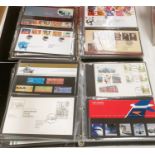 A collection of GB stamps in four ring binders, presentation packs, first day covers etc