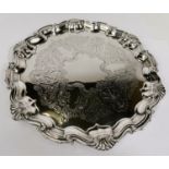 A hallmarked silver Georgian style salver with wavy shell border on 3 ball and claw feet,