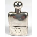 A hallmarked silver hip flask with integral stirrup cup, with embossed shield, Birmingham 1910, 4oz.