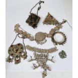 A selection of Asian jewellery including pendants, bracelets and finger jewellery.