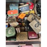 A collection of vintage advertising and commemorative tins of various sizes