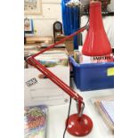 A vintage red angle poise desk lamp.