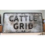 A vintage cast metal 'cattle grid' sign.