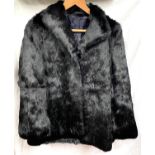 A short black Coney Fur Jacket.