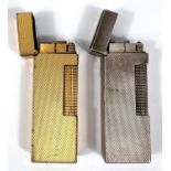 2 vintage Alfred Dunhill lighters - one gilt, one silver plate, with engine turned decoration.