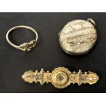 An Edwardian yellow metal bar brooch with filigree decoration and diamond chip; an oval chased