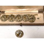 An Art Nouveau set of gilt cased buttons, floral pierced decoration, in fitted cream presentation