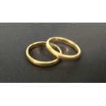 A 22 carat hallmarked gold wedding ring, size I; a similar ring, size K, gross weight 7gm