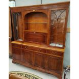 A Regency style reproduction yew wood side cabinet, full height with twin glazed cupboards and