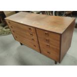 A 1970's teak side by side chest of 4 long and 4 short drawers, width 122cm