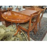 A Regency style reproduction yew wood dining suite comprising extending table with twin pedestals,