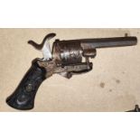 A 19th century Belgian pin fire six shot revolver, with carved grip and etched metal ware stamped