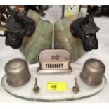 A desk top inkstand/calendar; a pair of onyx bookends in the form of dogs' heads