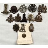 A selection of military badges including Lancashire Hussars, Army Cyclist Corps, The Queen's Lancers