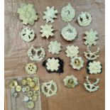 A good selection of military cap badges and buttons including Royal Highlanders etc