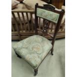 An Edwardian mahogany nursing chair in floral brocade; a 1930's child's armchair