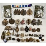 A selection of military badges and buttons including Middlesex Regiment, The King's Own etc