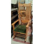 A period style pine rocking chair with tall stick back