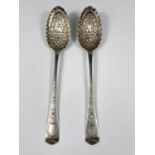 An 18th century pair of berry spoons with later relief decoration, bottom marked unclearly, 3.75oz