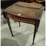 An early 20th century mahogany period style writing table with hinged back, inset leather top and