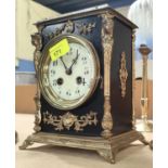 An ornate 19th century gilt metal and black mantle clock with striking French drum movement, ht.