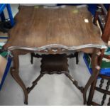 An Edwardian oak occasional table with scalloped square top, fretwork frieze and undershelf