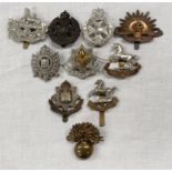 A selection of military badges including Cheshire, London Rifle Brigade, Australian Commonwealth