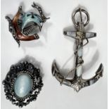 A large Victorian silver brooch in the form of an anchor with polished agate mounts; a silver and