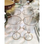 A set of 6 Murano wine glasses the bowls with swirl design and gold rims