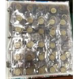 An album of GB and world coins including many old round pounds, commemorative and Olympic 50p coins,