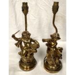 A pair of composition classical style gilt table lamps, cherubs playing instruments