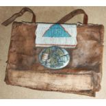 An early 20th century American leather military bag with applied metal USA badge and earlier panel